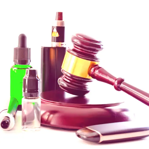 Vape and accersories next to a gavel.