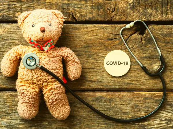 Covid 19 , a stethoscope and a teddy bear.